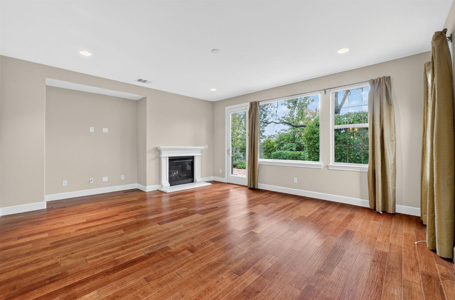 2050 Impressionist Way El Dorado Hills, CA 95762 - Photo 28 of 83 a view of empty room with wooden floor and fireplace