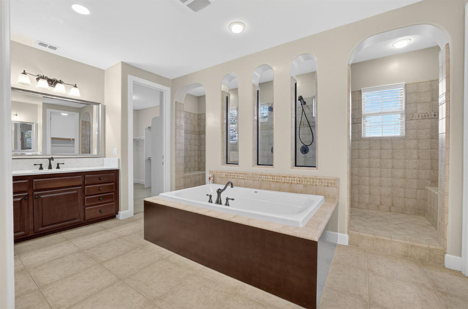 2050 Impressionist Way El Dorado Hills, CA 95762 - Photo 63 of 83 a spacious bathroom with a tub sink shower and mirror