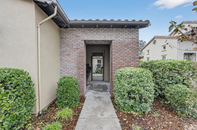 a view of an empty room with a fireplace and a window