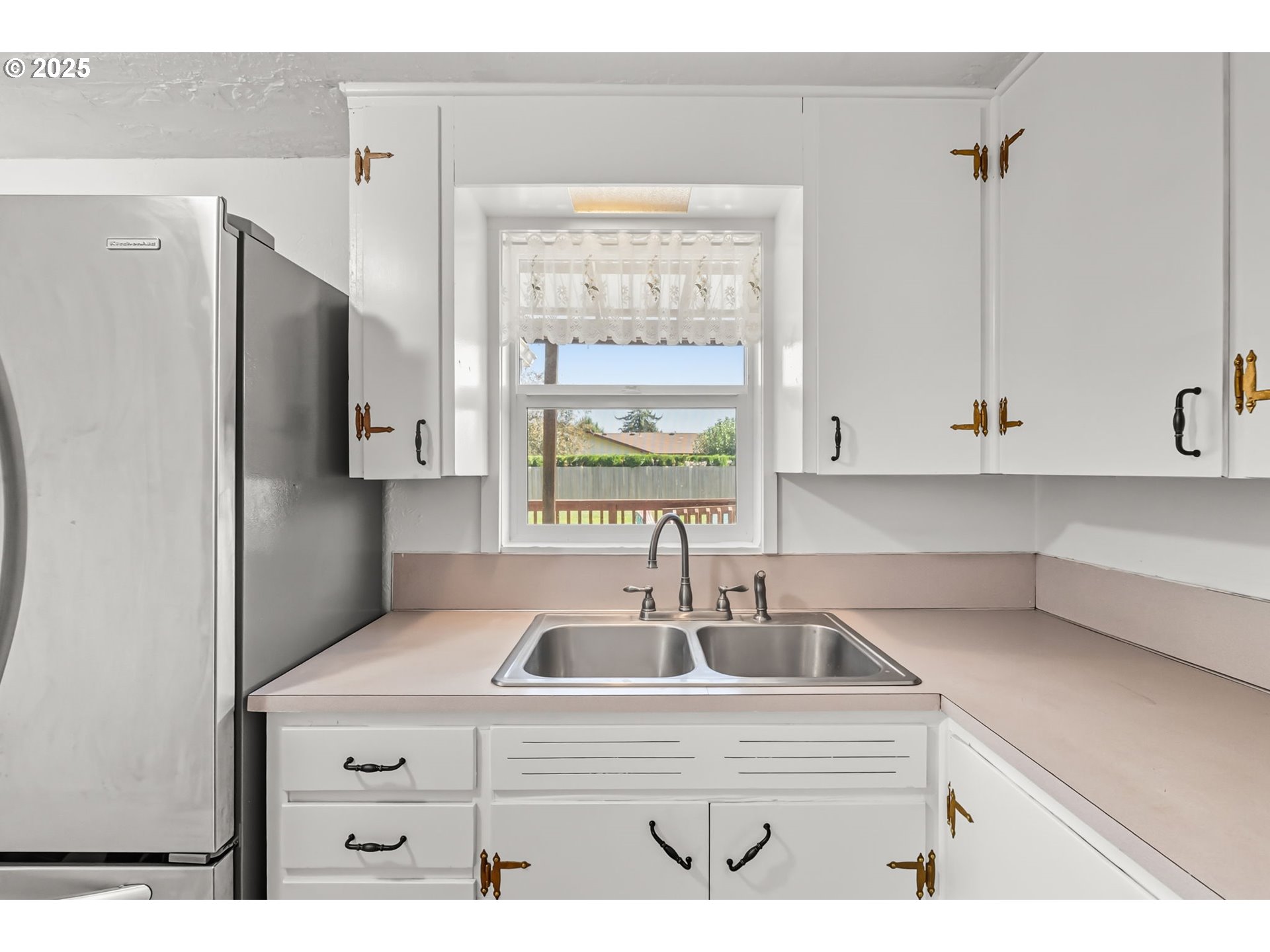 1025 54th Street Springfield, OR 97478 - Photo 8 of 31 a kitchen with a sink cabinets and window