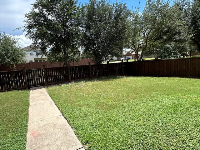 a view of swimming pool with wooden fence