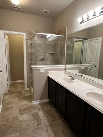 a bathroom with a sink double vanity and a mirror