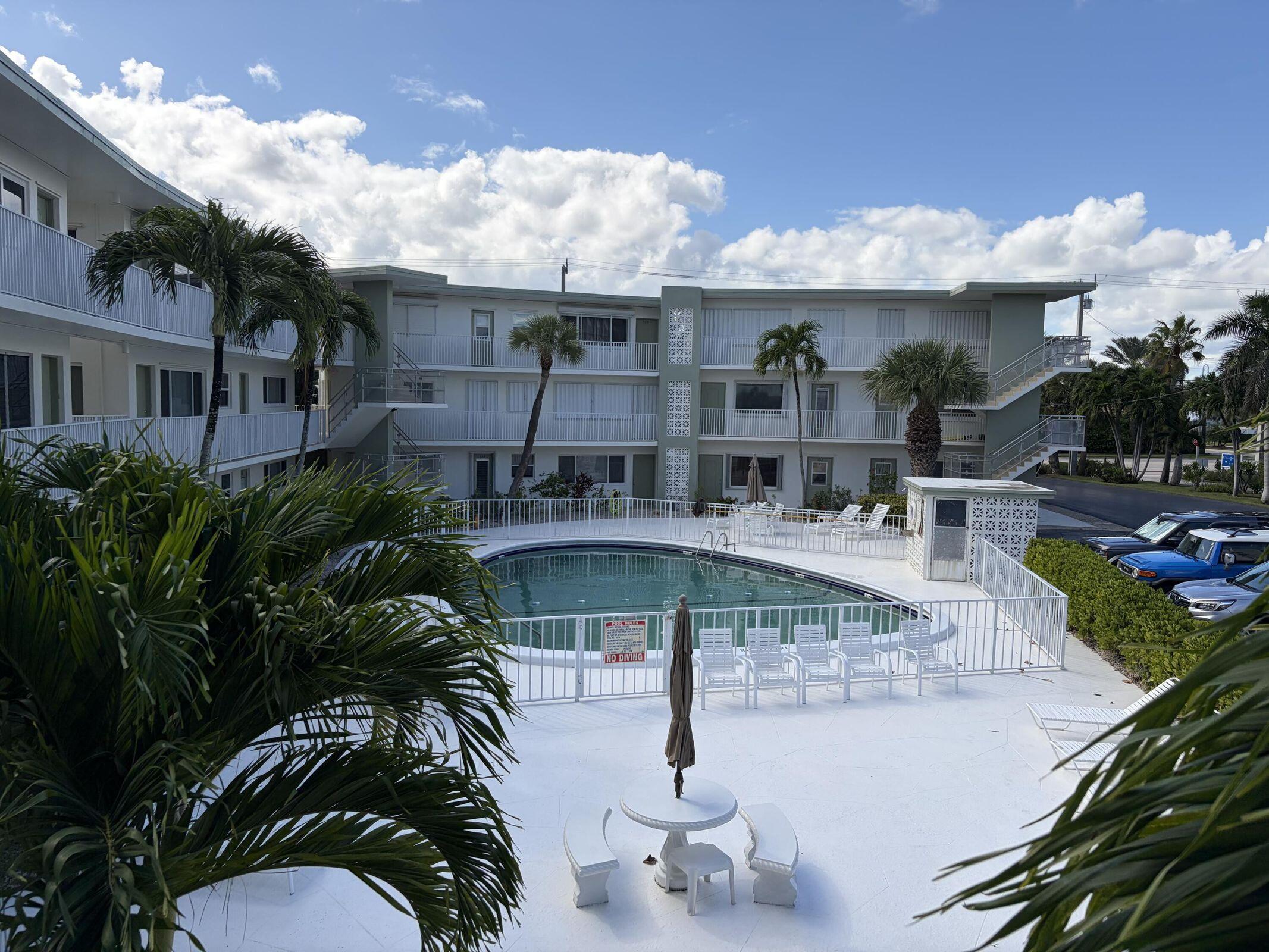 an aerial view of a house with swimming pool and patio