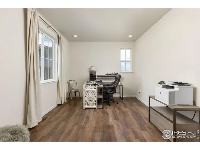 a workspace with furniture and wooden floor