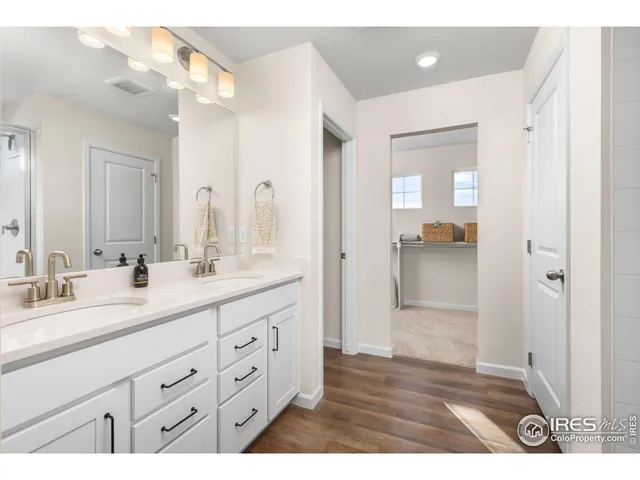 a bathroom with a shower sink and mirror