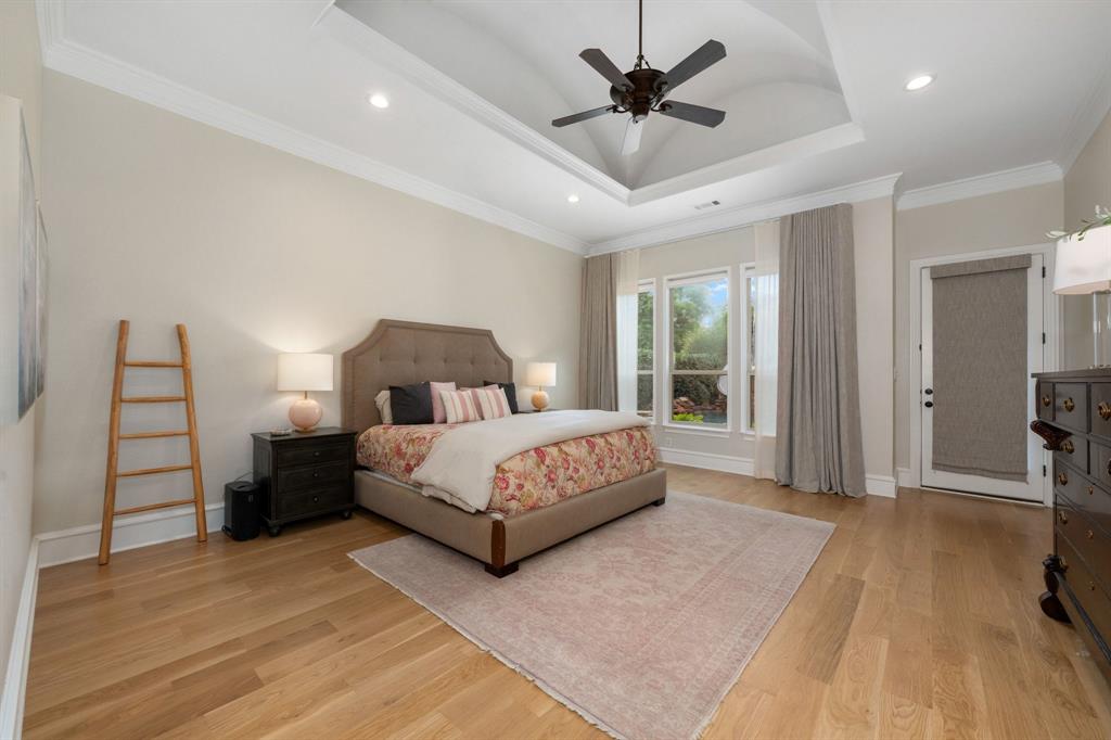 2101 Vail Road Southlake, TX 76092 - Photo 21 of 40 a spacious bedroom with a bed and a chandelier