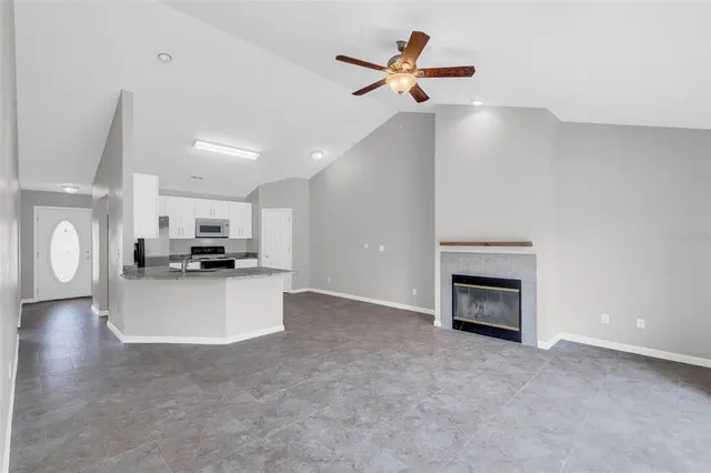 a view of living room with furniture and a fireplace