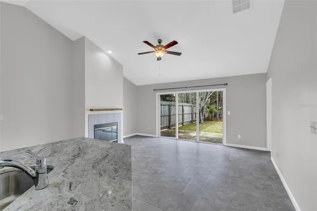 a view of a bedroom with furniture and a ceiling fan