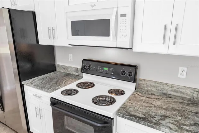 a kitchen with appliances cabinets and a counter space