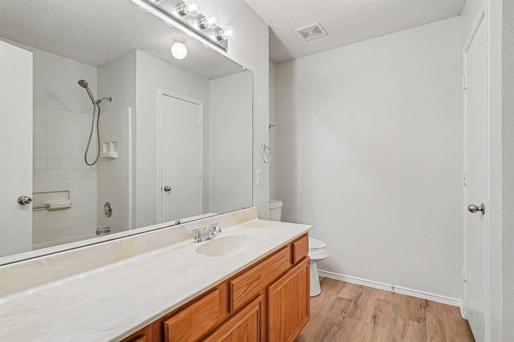 2541 Rivers Edge Drive Fort Worth, TX 76118 - Photo 16 of 31 a bathroom with a sink and a mirror