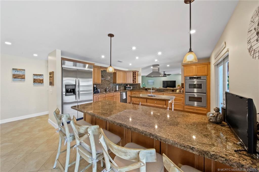 7 Island Road Stuart, FL 34996 - Photo 19 of 67 a kitchen with stainless steel appliances granite countertop a sink and a stove
