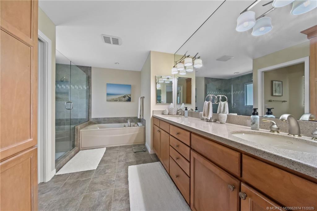 7 Island Road Stuart, FL 34996 - Photo 25 of 67 a bathroom with a granite countertop sink mirror and bathtub