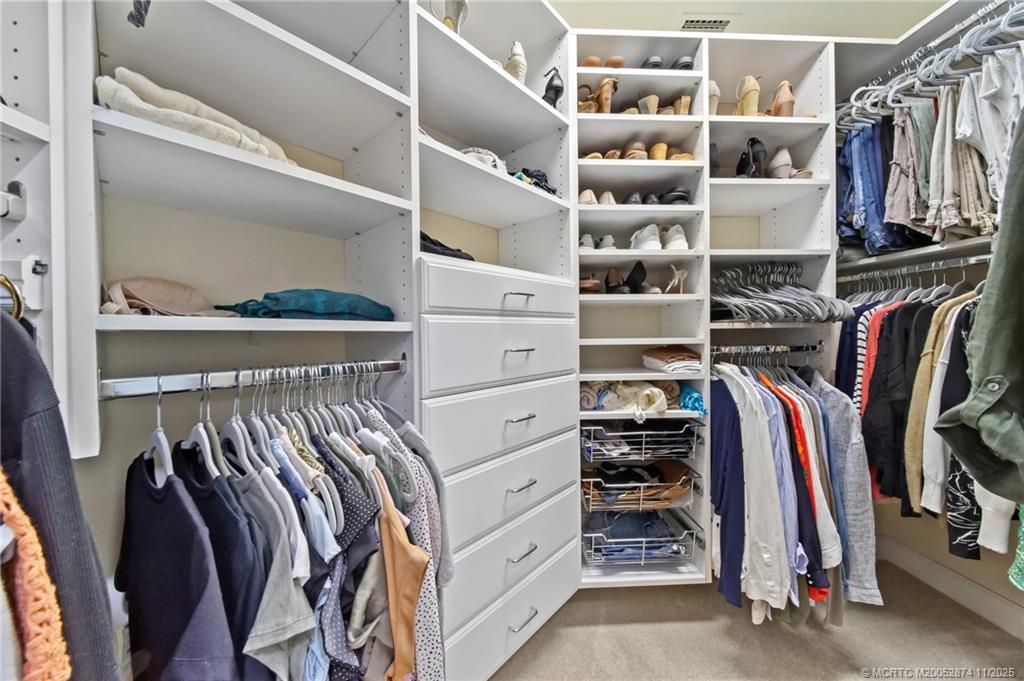7 Island Road Stuart, FL 34996 - Photo 29 of 67 a view of walk in closet with clothes and shoes