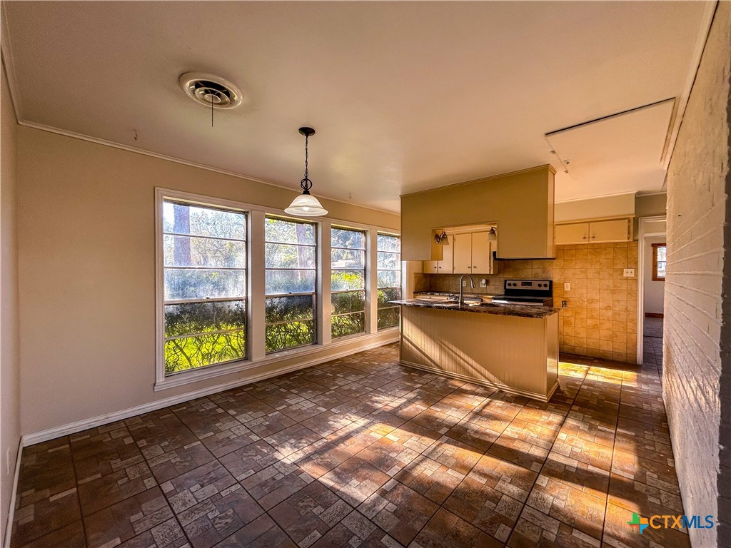 902 Joplin Street Victoria, TX 77904 - Photo 16 of 43 a view of a kitchen with kitchen island granite countertop a refrigerator and a sink