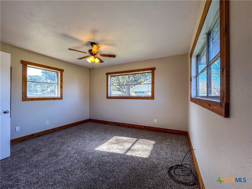 902 Joplin Street Victoria, TX 77904 - Photo 21 of 43 a view of an empty room with window and chandelier fan
