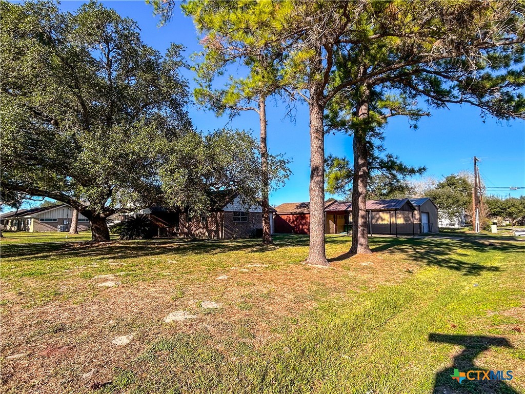 902 Joplin Street Victoria, TX 77904 - Photo 43 of 43 a view of a swimming pool with an outdoor seating and a yard