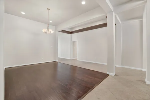 an empty room with windows and fireplace