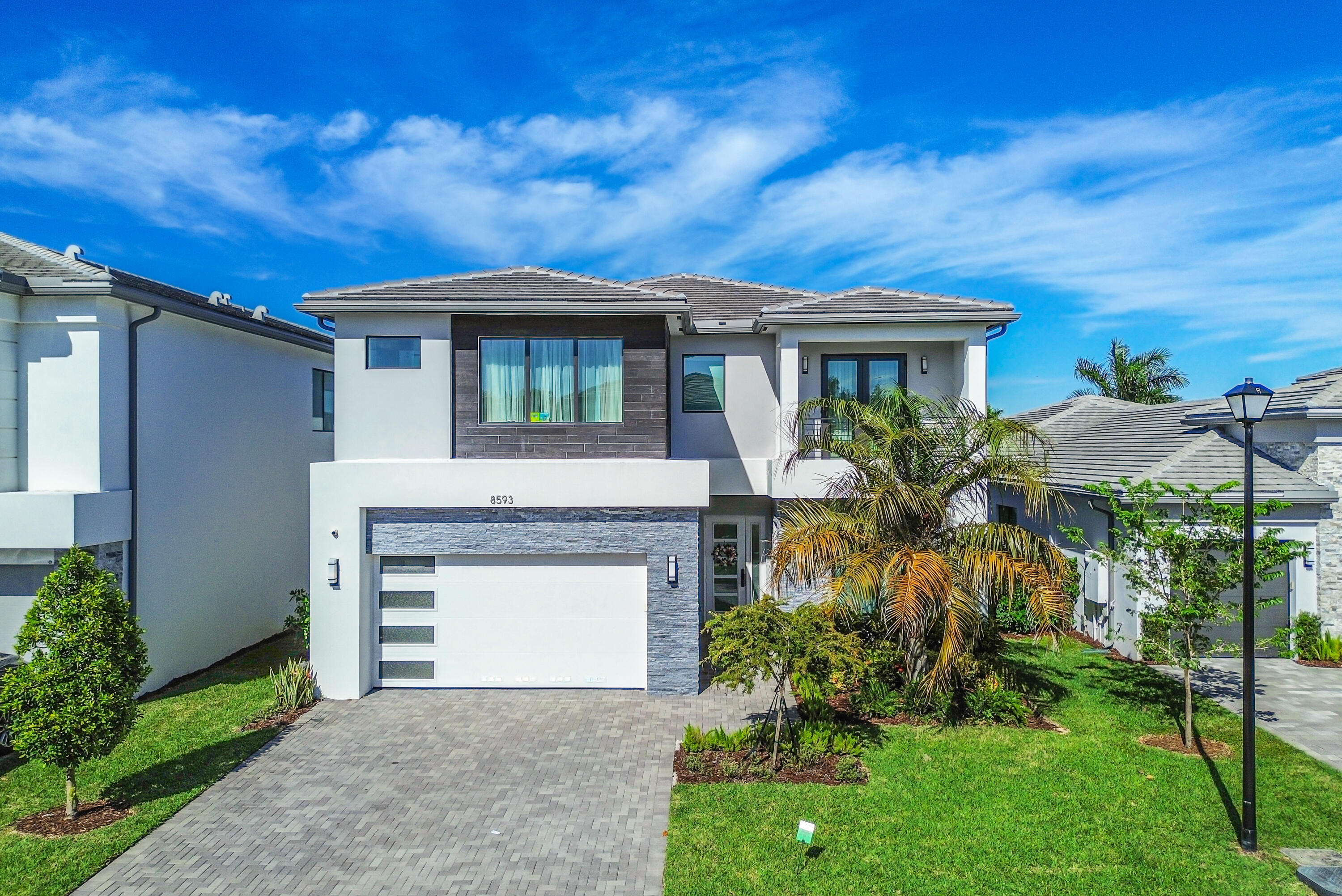 8593 Swinley Frst Way Boca Raton, FL 33434 - Photo 17 of 35 a front view of a house with a garden
