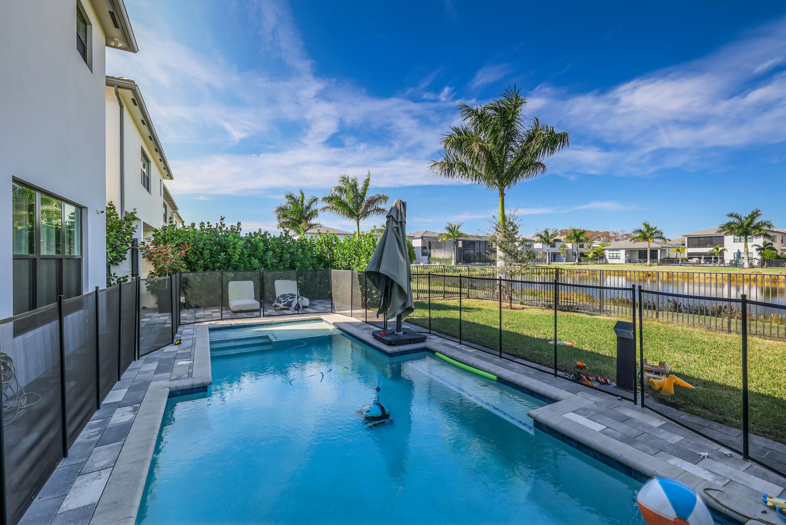 8593 Swinley Frst Way Boca Raton, FL 33434 - Photo 4 of 35 a view of a swimming pool with a lounge chairs