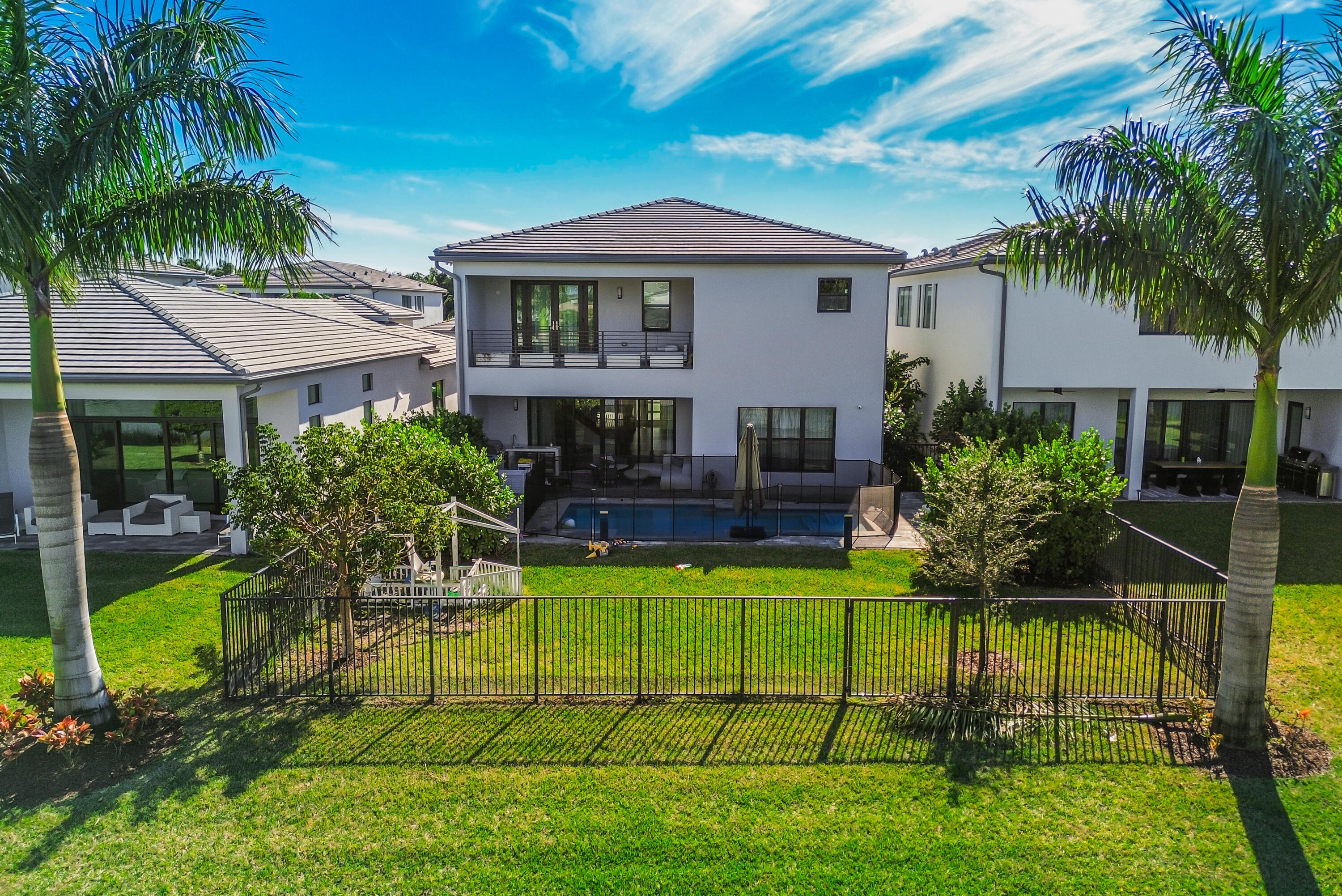 8593 Swinley Frst Way Boca Raton, FL 33434 - Photo 5 of 35 a house view with a garden space and swimming pool