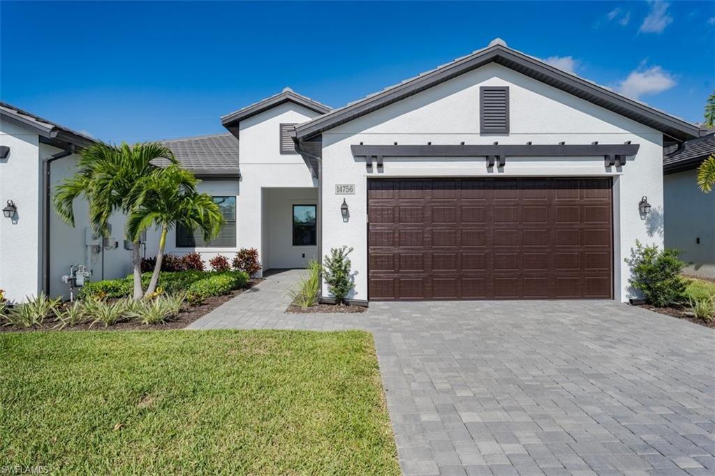 a front view of a house with garage