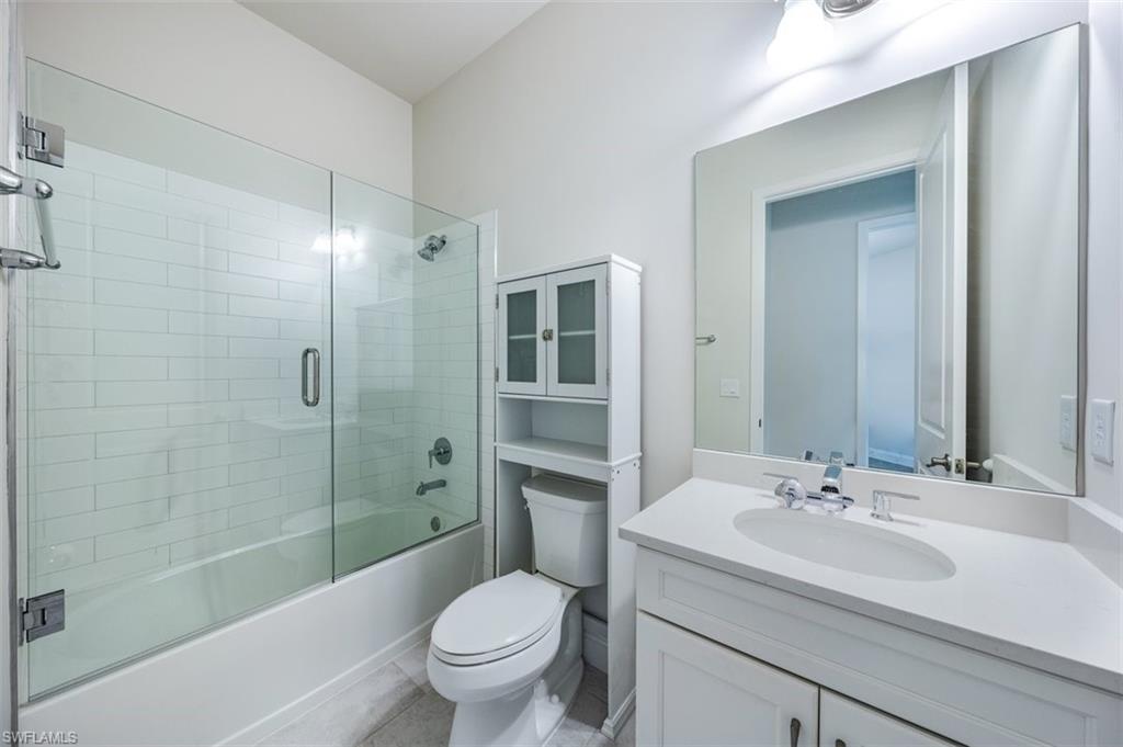 14756 Kingfisher Loop Naples, FL 34120 - Photo 11 of 16 a bathroom with a sink toilet and shower