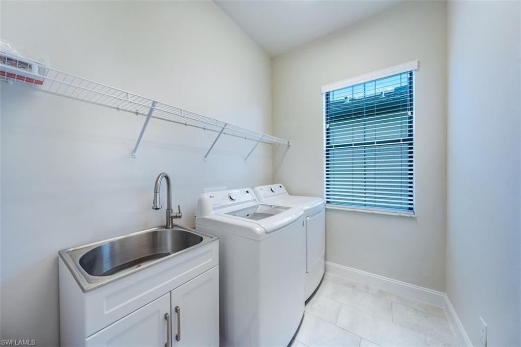 14756 Kingfisher Loop Naples, FL 34120 - Photo 12 of 16 a utility room with dryer and washer