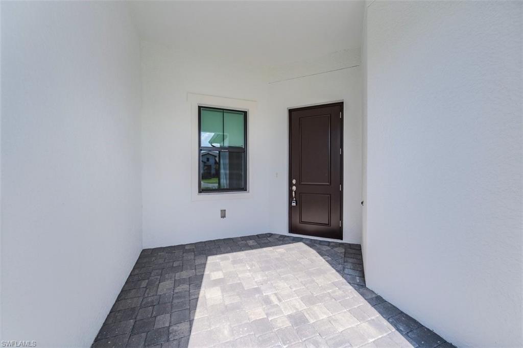 14756 Kingfisher Loop Naples, FL 34120 - Photo 13 of 16 a view of an empty room with window