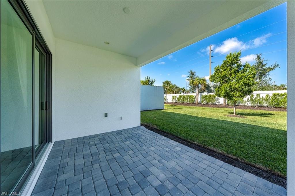 14756 Kingfisher Loop Naples, FL 34120 - Photo 14 of 16 a view of a house with a yard