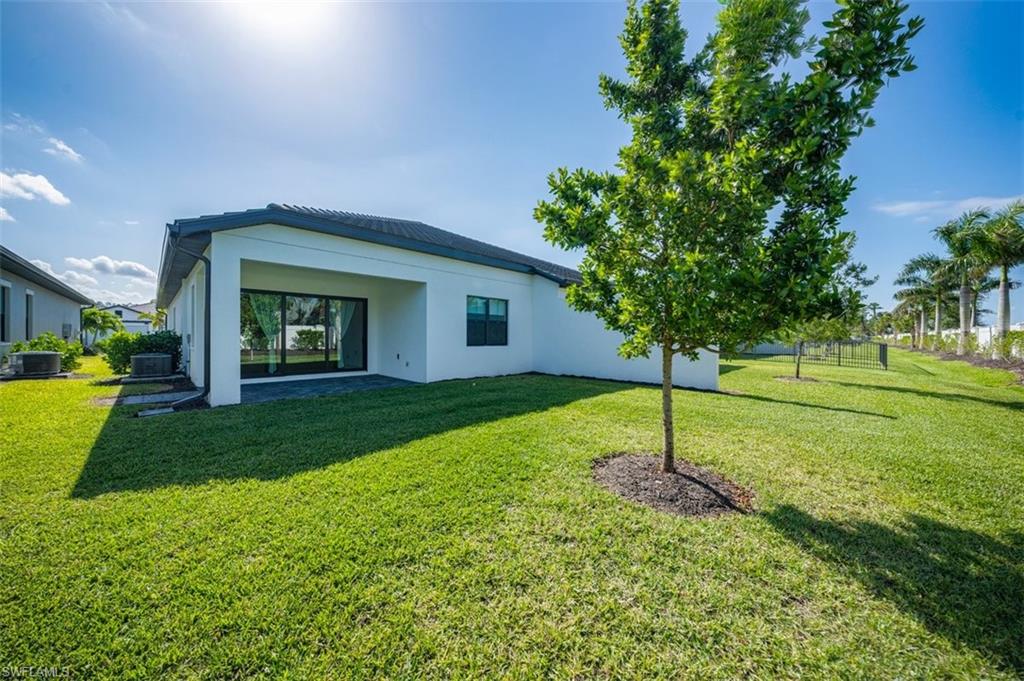 14756 Kingfisher Loop Naples, FL 34120 - Photo 16 of 16 a house with a garden