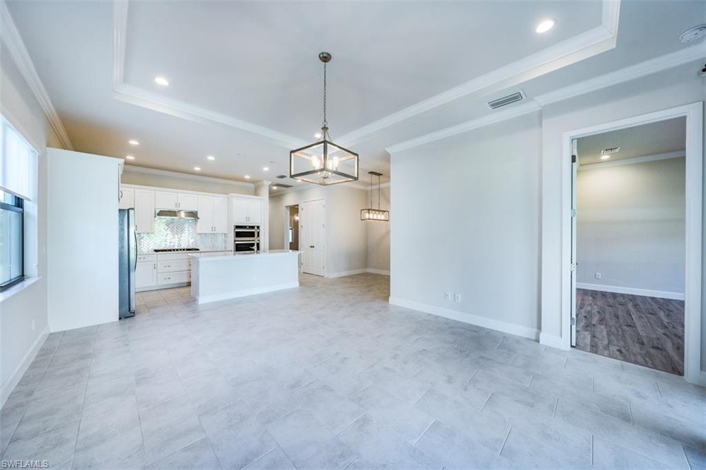 14756 Kingfisher Loop Naples, FL 34120 - Photo 4 of 16 a view of a kitchen with a refrigerator and microwave