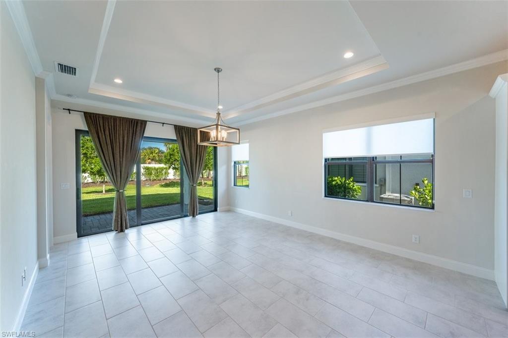 14756 Kingfisher Loop Naples, FL 34120 - Photo 5 of 16 a view of an entryway with floor to ceiling windows