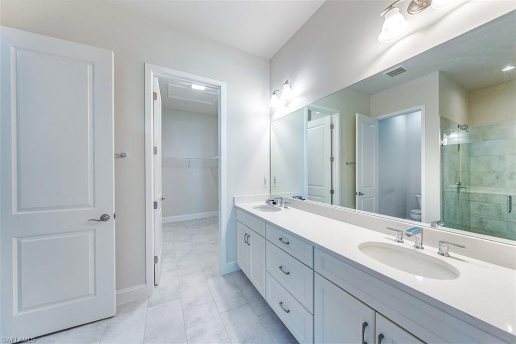 14756 Kingfisher Loop Naples, FL 34120 - Photo 7 of 16 Master Bathroom - dual sinks, walk-in closet