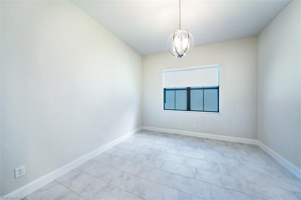 14756 Kingfisher Loop Naples, FL 34120 - Photo 8 of 16 a view of an empty room with a window