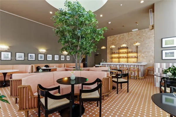a dining room with furniture and a potted plant