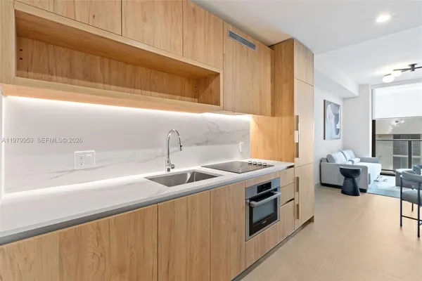 a kitchen with stainless steel appliances granite countertop a sink and a stove