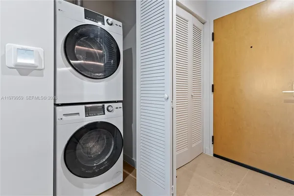 a view of a hallway with washer and dryer