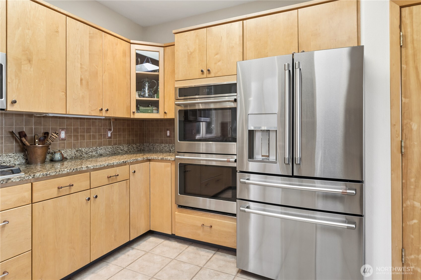 1355 Jackman Street Port Townsend, WA 98368 - Photo 12 of 38 a kitchen with granite countertop white cabinets and stainless steel appliances