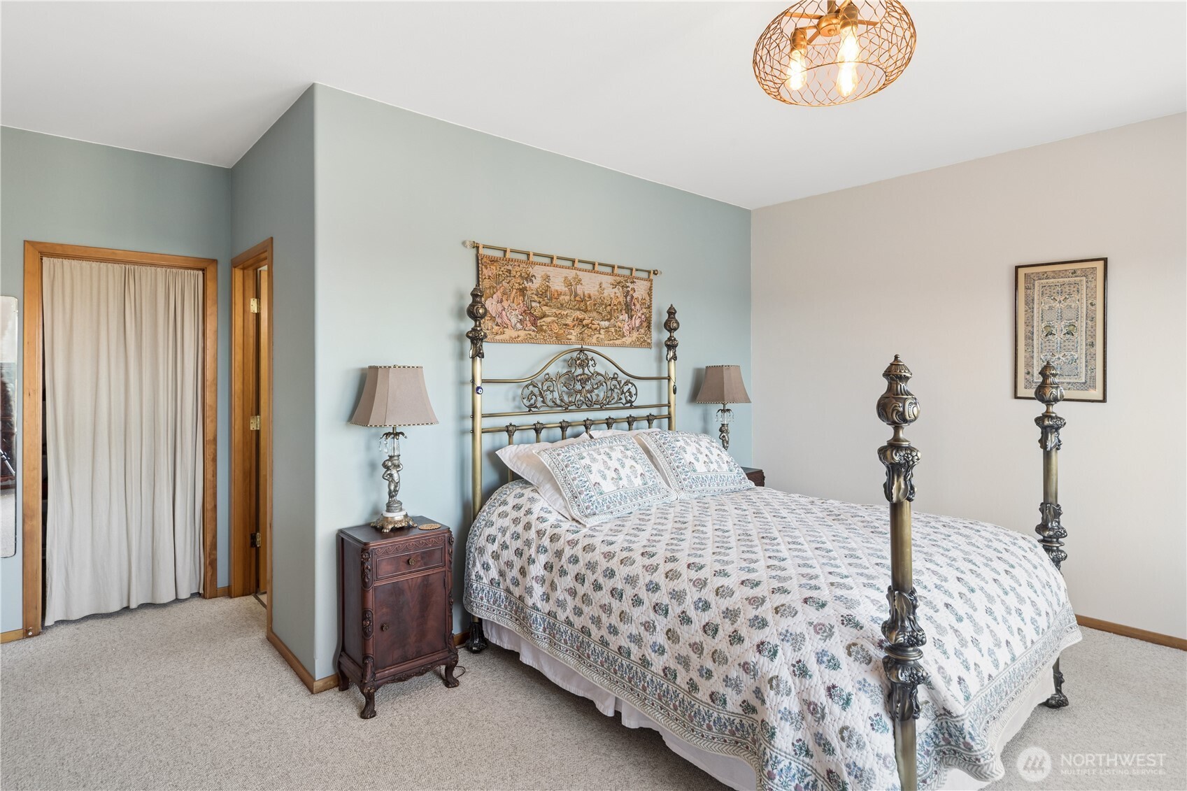 1355 Jackman Street Port Townsend, WA 98368 - Photo 13 of 38 a bedroom with a bed and a chandelier