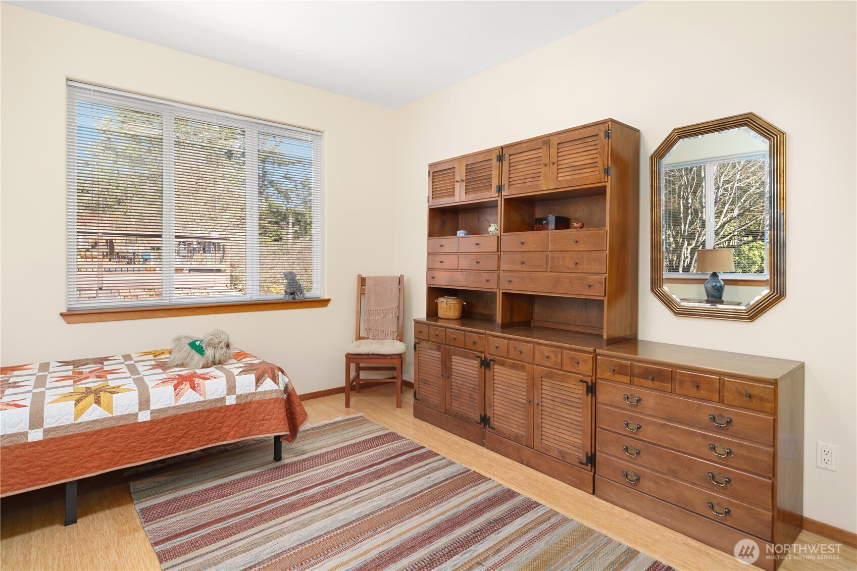 1355 Jackman Street Port Townsend, WA 98368 - Photo 19 of 38 a spacious bedroom with a bed a dresser and potted plants on the dresser