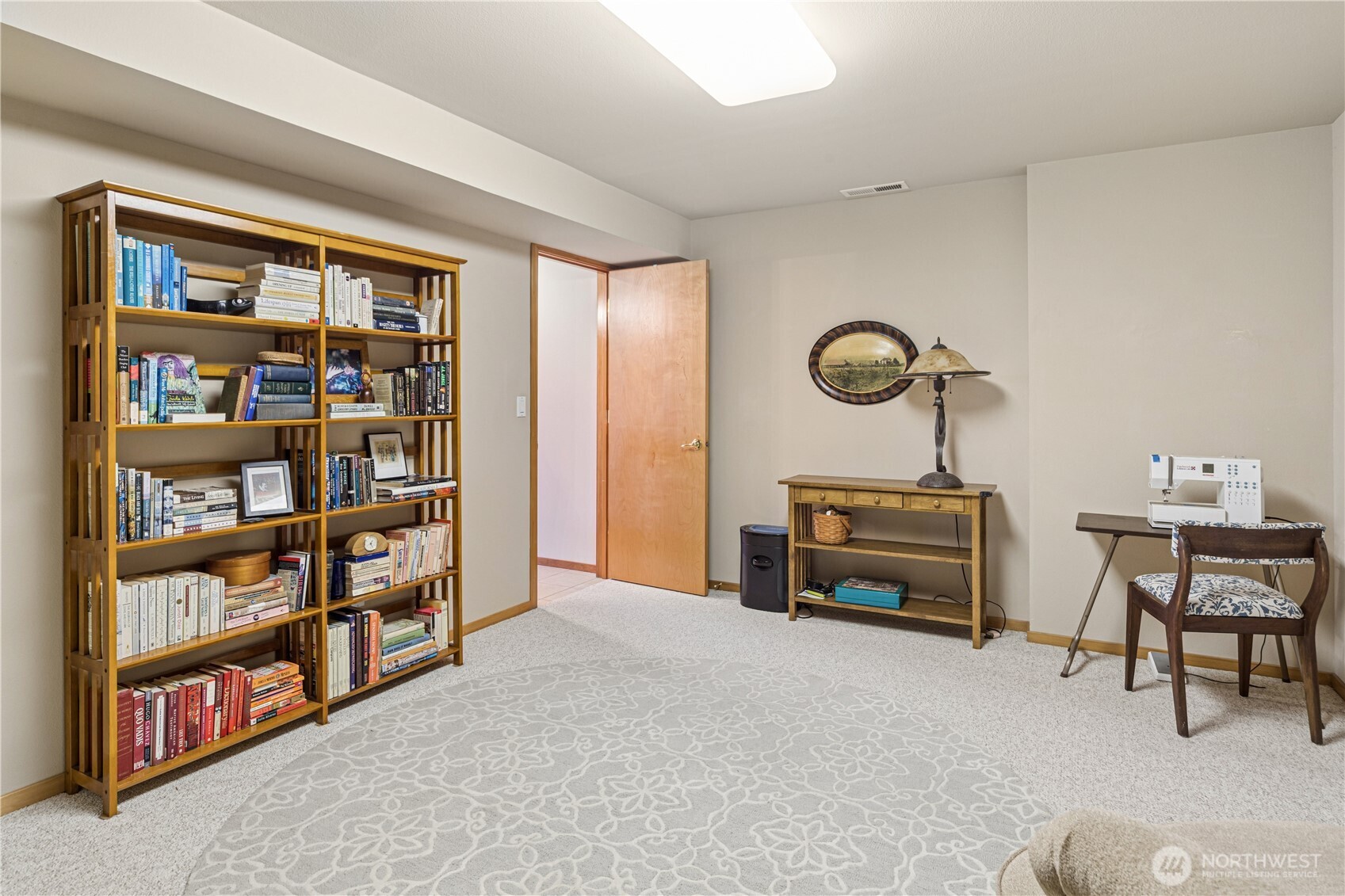 1355 Jackman Street Port Townsend, WA 98368 - Photo 26 of 38 a bedroom with furniture and a book shelf