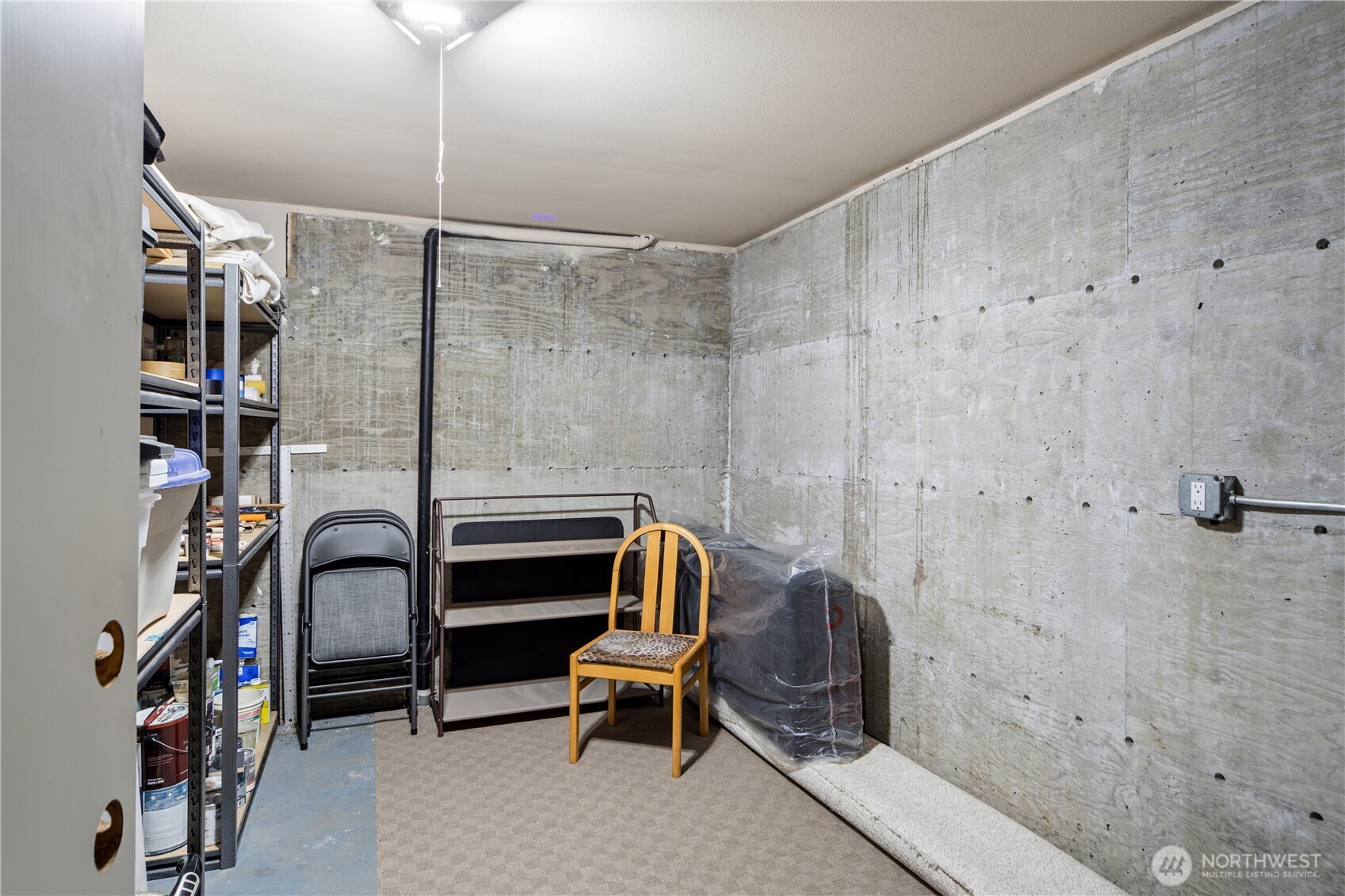 1355 Jackman Street Port Townsend, WA 98368 - Photo 30 of 38 a bedroom with a bed and a chandelier