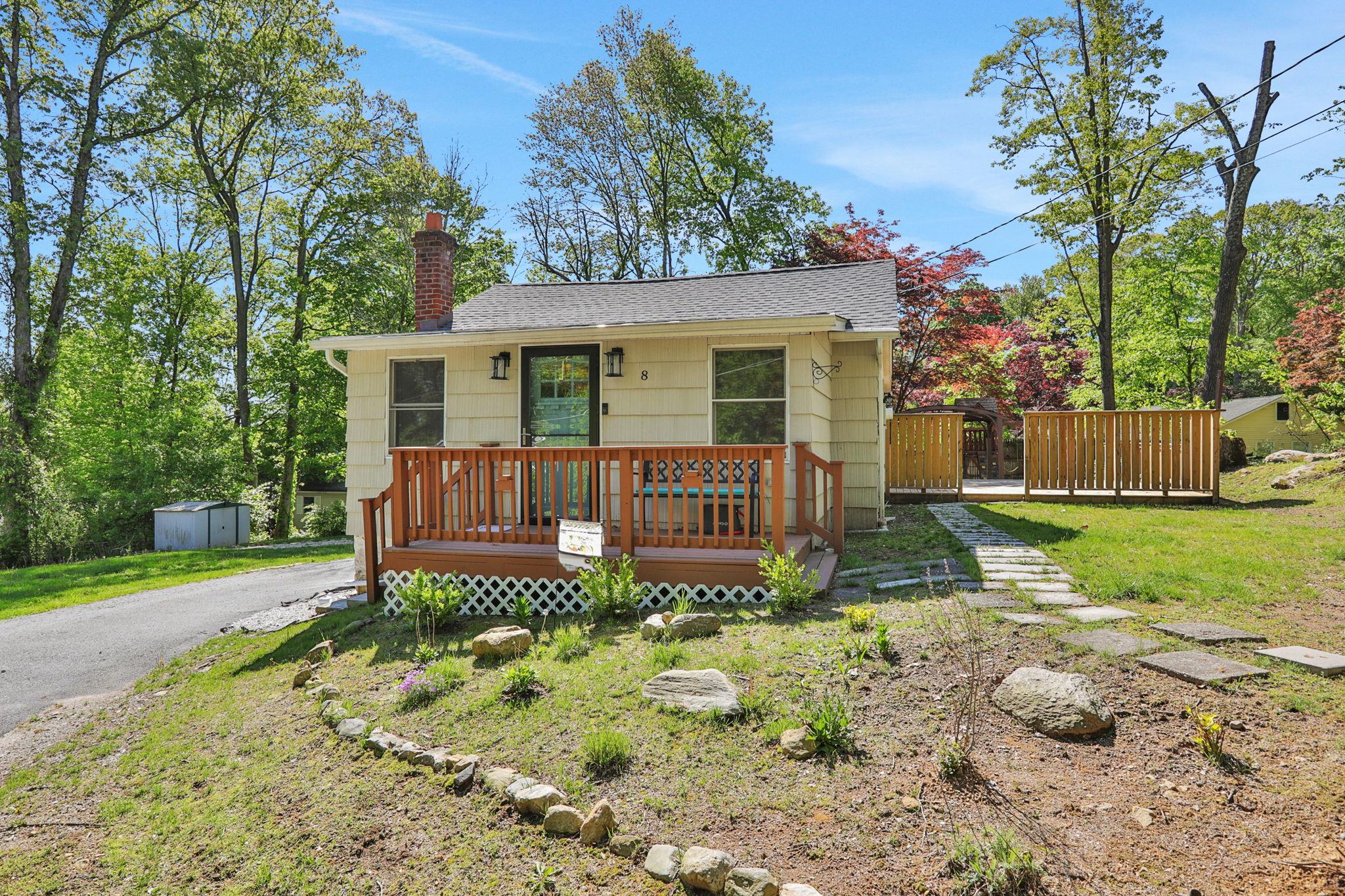 8 Copake Falls Road Carmel, NY 10512 - Photo 1 of 1 View of front facade featuring a storage shed, an outbuilding, a chimney, a shingled roof, and a deck