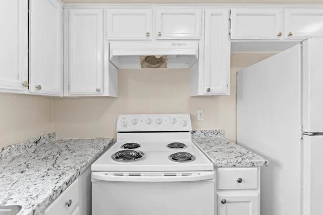 a kitchen with a sink a window and a cabinets
