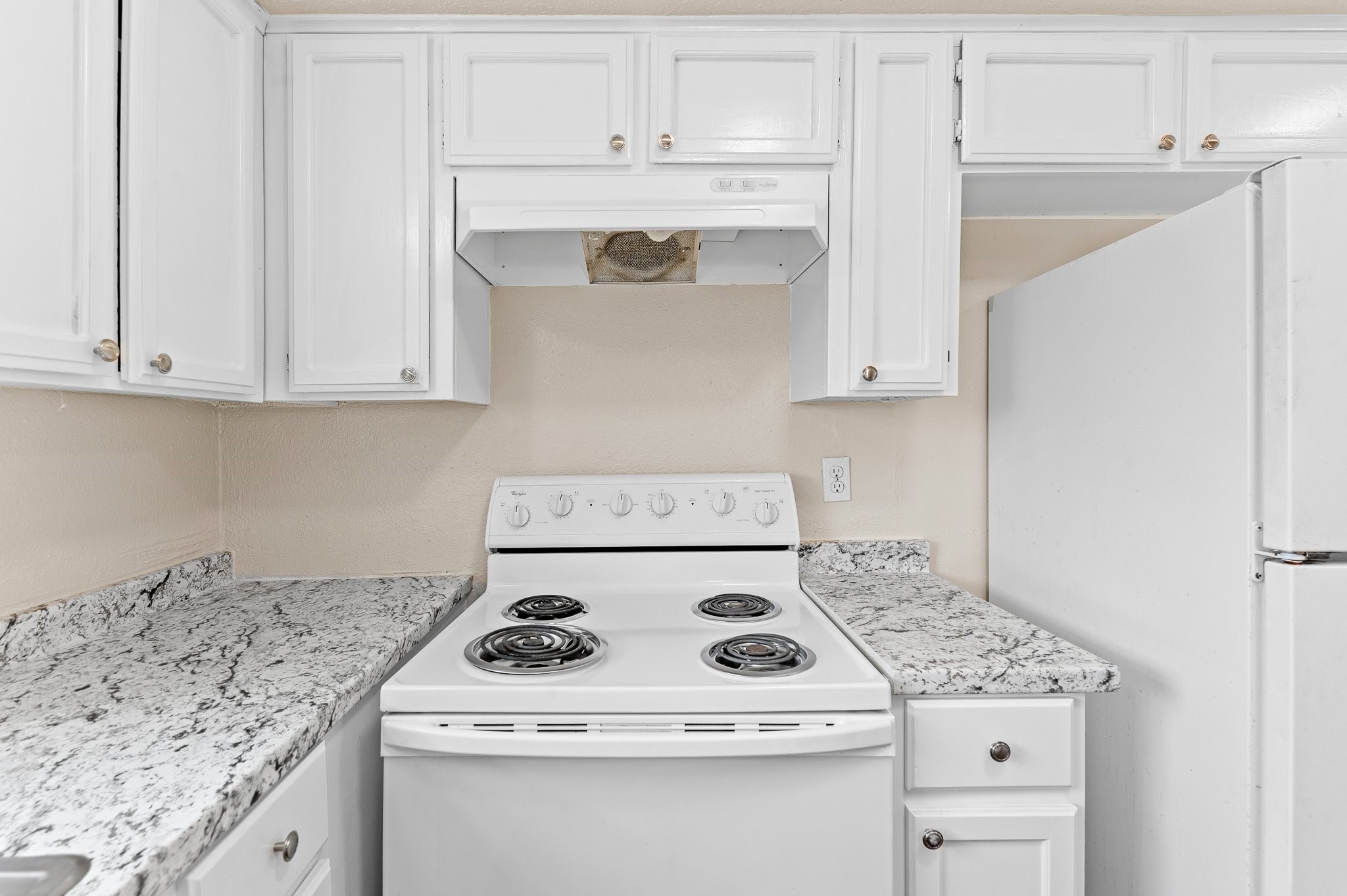 8412 Garcreek Circle, Unit D Austin, TX 78724 - Photo 12 of 23 a white stove top oven sitting inside of a kitchen