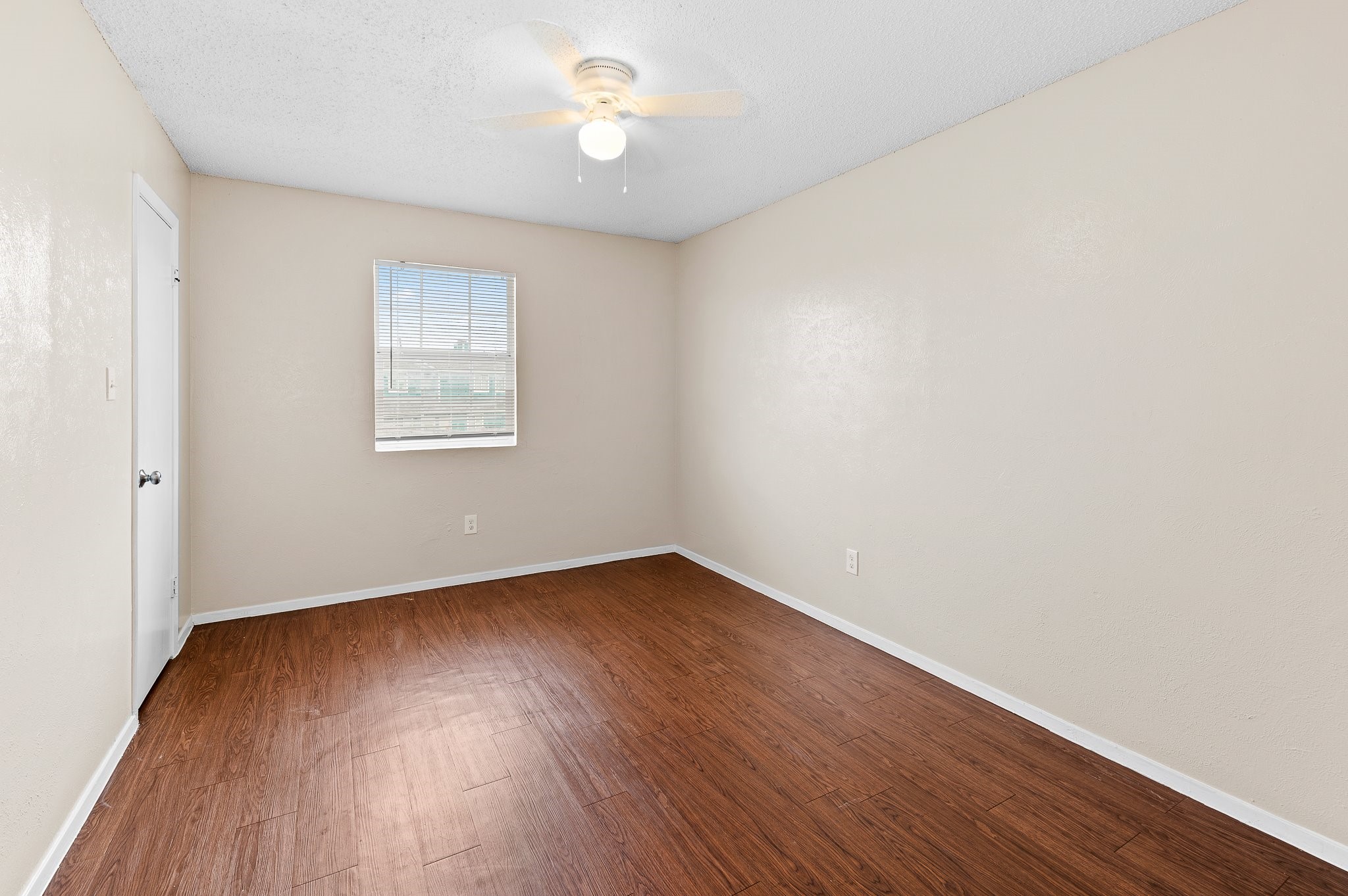 8412 Garcreek Circle, Unit D Austin, TX 78724 - Photo 18 of 23 an empty room with wooden floor and windows