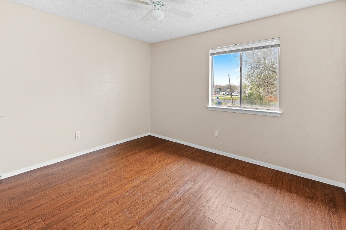8412 Garcreek Circle, Unit D Austin, TX 78724 - Photo 19 of 23 an empty room with wooden floor and windows