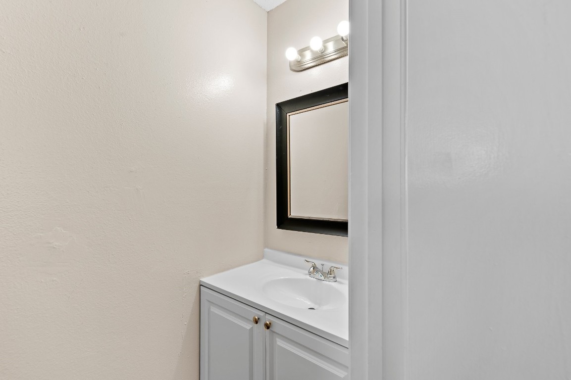 8412 Garcreek Circle, Unit D Austin, TX 78724 - Photo 7 of 23 a bathroom with a sink a light fixture and a mirror
