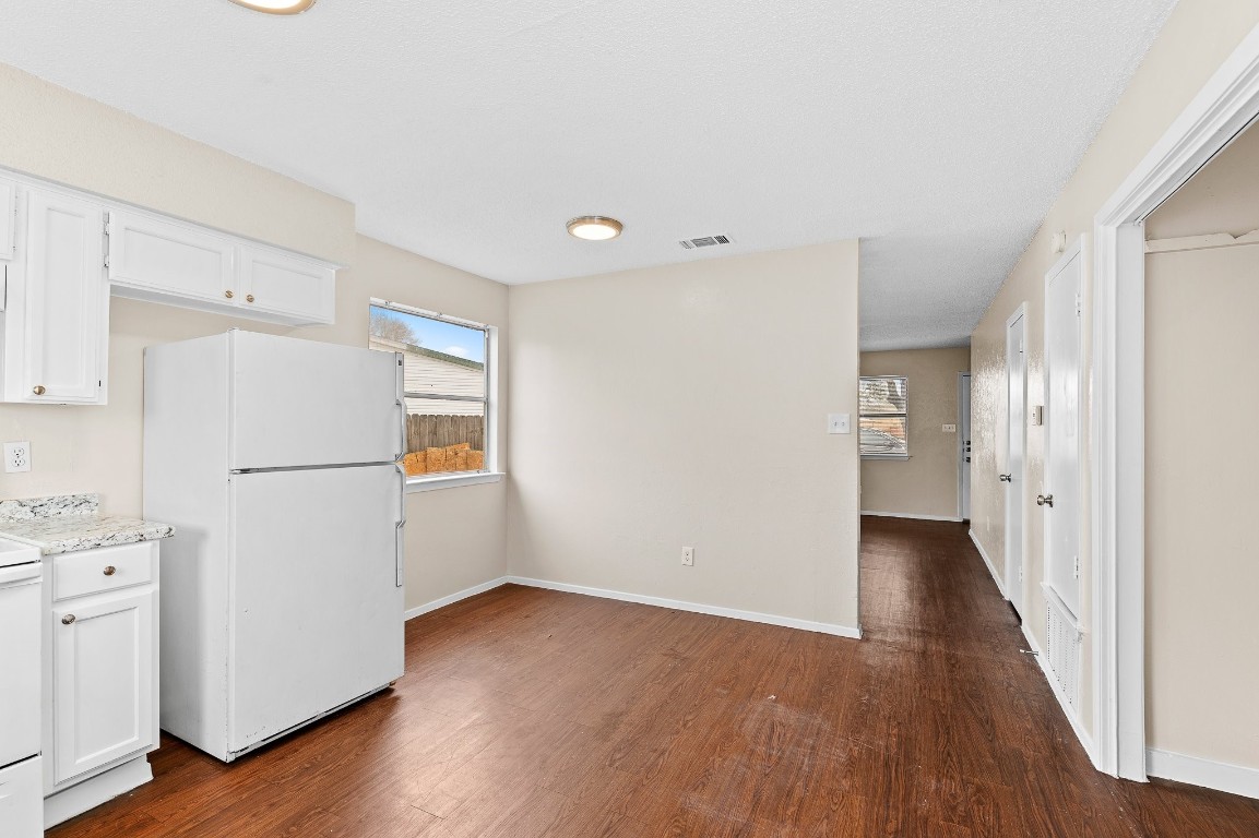 8412 Garcreek Circle, Unit D Austin, TX 78724 - Photo 9 of 23 a view of a kitchen with a refrigerator cabinets and wooden floor