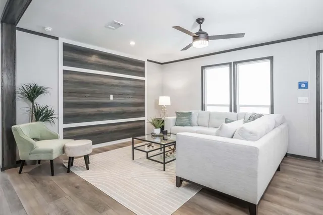 a living room with furniture and a potted plant